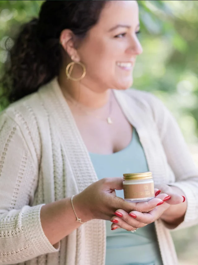Founder of HEKAL holding a jar of Sanctuary Cream